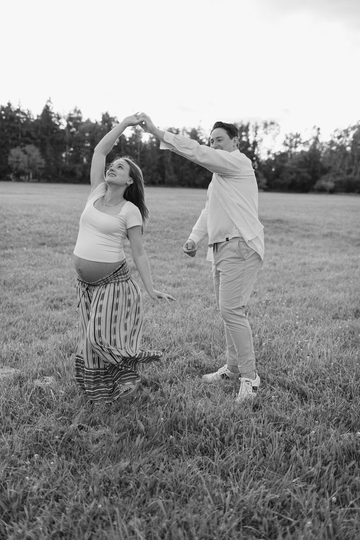 Black-and-white maternity portrait in an open field — Home Team Photography