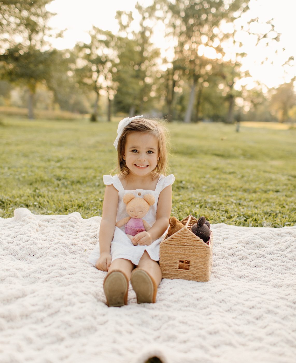 Little girl on a blanket with a picnic basket at golden hour — Home Team Photography