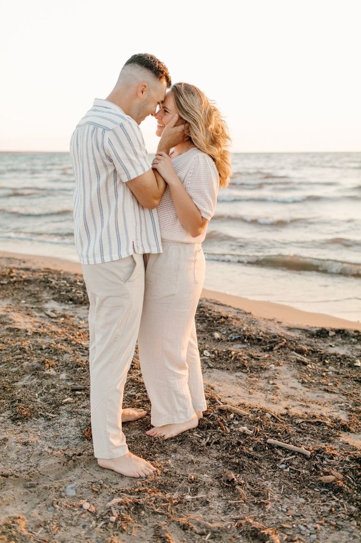 Couple nose-to-nose at golden hour on a Western New York beach — engagement portrait by Home Team Photography