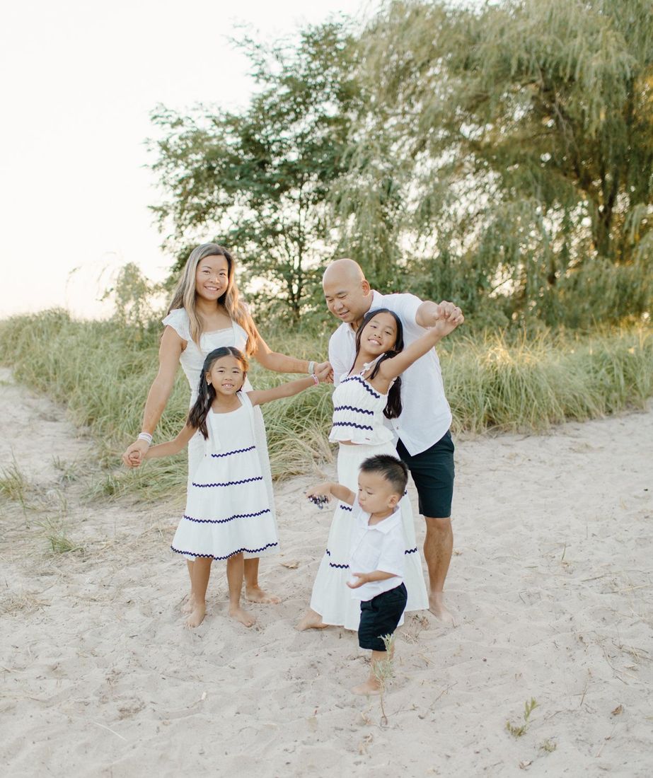 Family of five playing together on the beach at golden hour — Home Team Photography