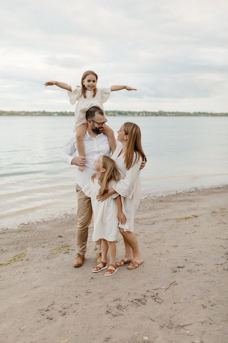The Martin family in coordinated white outfits on a Western New York beach — Home Team Photography